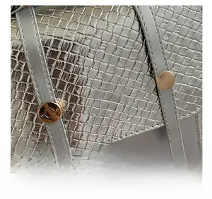 Detail of silver woven texture and gold rivets on the stylish metallic backpack