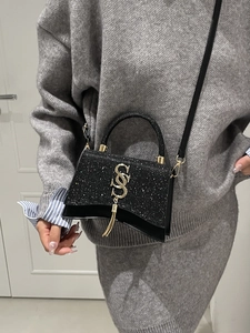 Chic black glitter handbag with curved base and golden logo for women’s casual fashion