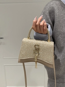 Sparkling champagne gold crossbody handbag with vintage chain and fringe logo detail