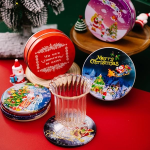 Close-up of festive Christmas tin boxes with Santa and reindeer prints for table decor