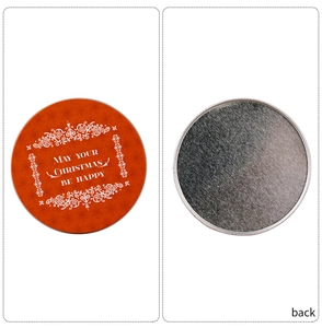 Detailed view of round Christmas tin coasters showing orange front and anti-slip back