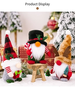 Detailed view of festive Christmas gnomes with plaid hats and candy canes on snow