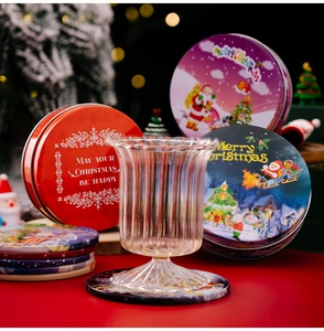 Christmas tin coaster set featuring Santa and reindeer prints on festive red table
