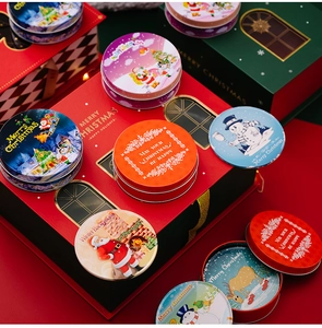 Close-up of festive Christmas tin boxes with Santa and reindeer illustrations for decor