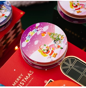 Close-up of a tinplate Christmas gift box with Santa Claus and snowman festive prints
