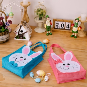 Easter pink and blue rabbit gift bags with white bunny ears on a cozy wooden table