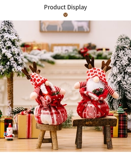 Detail of Christmas reindeer dwarf gift bags with red plaid hats on a wooden stool