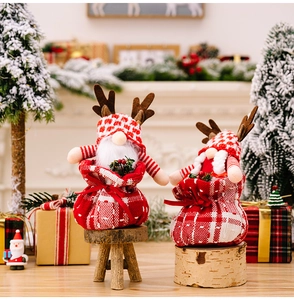 Detail of Rudolph gnome plush in red plaid gift bag with brown antlers for Christmas