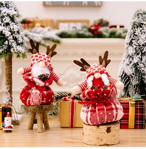 Close-up of Christmas gnome plush in reindeer antler gift bag on a festive wooden background