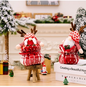 Detail of Christmas gnome gift bags with reindeer antlers and red-white checkered patterns
