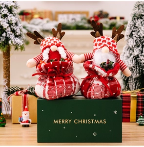 Detail of plush Christmas gnomes with reindeer antlers in festive checkered gift bags