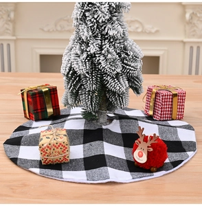 Close-up of black and white buffalo plaid mini tree skirt in a cozy Christmas scene