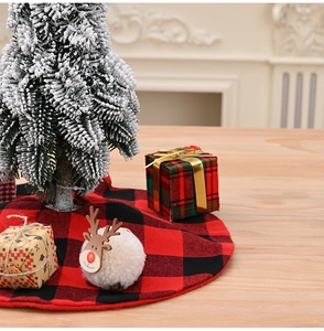 Detail of red and black buffalo plaid Christmas tree skirt with festive holiday decor