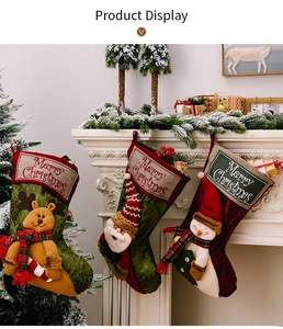 Detailed view of three hanging Christmas stockings featuring 3D reindeer, Santa, and snowman