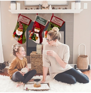 Three-piece Christmas stockings set with Santa, Snowman, and Reindeer hanging on a fireplace