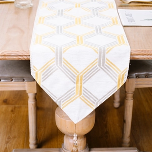 Modern cream table runner with gold grey geometric hexagons and beaded tassels