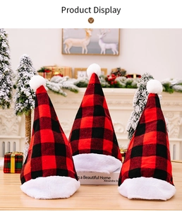 Three red and black buffalo plaid Christmas hats with white plush trim by a fireplace