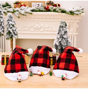 Detail of red and black buffalo plaid Christmas hats with plush trim and resin ornaments