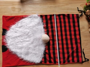 Detail of Santa Claus gift bag showing 50cm width measurement and buffalo plaid pattern