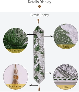 Detail of green leaf table runner with golden tassels and high-quality jacquard fabric texture