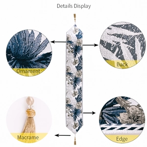 Detailed display of tropical flower table runner with macrame fringe and edge stitching