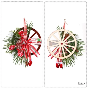 Front and back detail of Christmas wagon wheel wreath with elf legs and pine needles