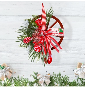 Close-up of Christmas wreath with wooden wheel base, elf legs, and Merry Christmas sign