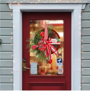 Close-up of a festive Christmas door wreath with red berries and a Merry Christmas sign
