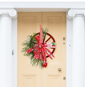 Detailed view of a rustic Christmas wheel wreath with Merry Christmas sign and bows
