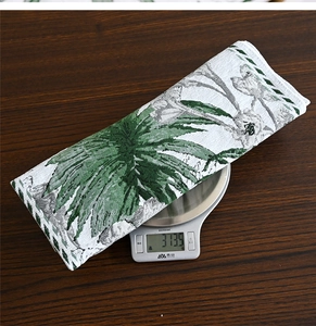 Detailed top view of a heavy weight 313.5g Christmas table runner with green ink floral art