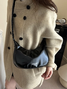Modern black glossy patent leather pleated shoulder bag for women in a chic half-moon shape