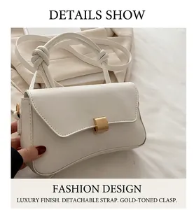 Close-up of white PU leather crossbody bag with golden buckle and knotted handle detail