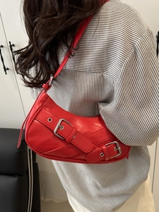 Red PU leather crescent underarm bag with vintage metal buckles on a striped shirt model