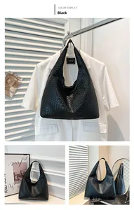 Detailed view of black woven PU leather hobo bag with large lattice knit pattern texture