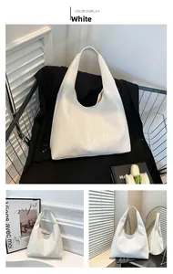 Detailed view of white woven leather hobo bag with dense crisscross texture pattern
