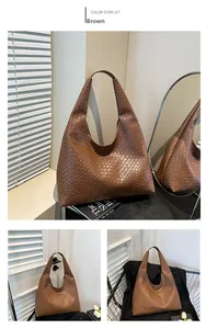 Close-up of brown woven leather texture on large capacity tote bag with natural shadow