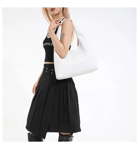 Close-up of white woven leather texture on a large shoulder tote bag for women