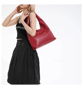 Detail of dark red woven leather hobo bag showing the intricate intrecciato texture