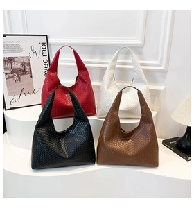 Collection of oversized woven texture tote bags in red, off-white, black, and mocha brown