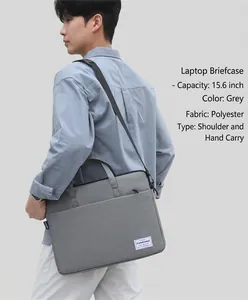 Detail of grey waterproof laptop bag with handle and fashion label in urban setting