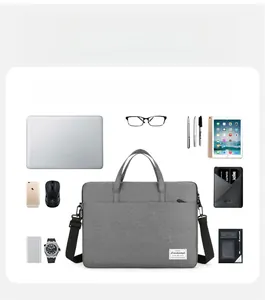 Detailed top view of a grey laptop bag with organized office accessories and gadgets