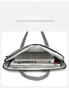 Spacious main compartment of grey laptop bag holding tablets and thick books