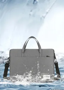 Waterproof grey laptop bag detail showing splash-resistant fabric and shoulder strap