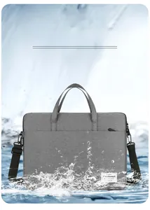 Waterproof grey laptop bag detail showing splash-resistant fabric and shoulder strap
