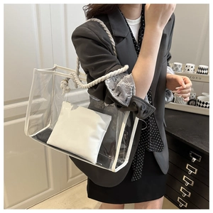 Detailed view of PVC tote bag with white leather trim and thick cotton rope handles