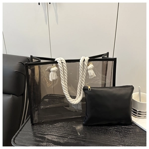 Detail of transparent PVC tote bag with black inner pouch and white rope handles