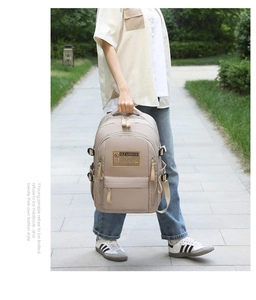 Detail view of khaki minimalist backpack with water-resistant fabric and large front pocket