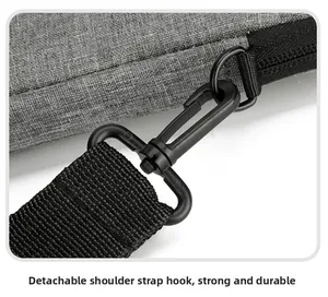 Detail of the durable detachable shoulder strap hook and textured gray fabric of the bag
