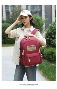 Outdoor view of a large burgundy ergonomic backpack with SLFASHION label on model