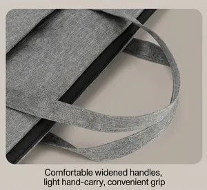 Close-up of the reinforced widened handle and smooth zipper on the gray laptop bag